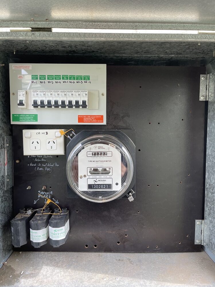 Meter box interior with a new breaker panel, meter and tagged service fuses